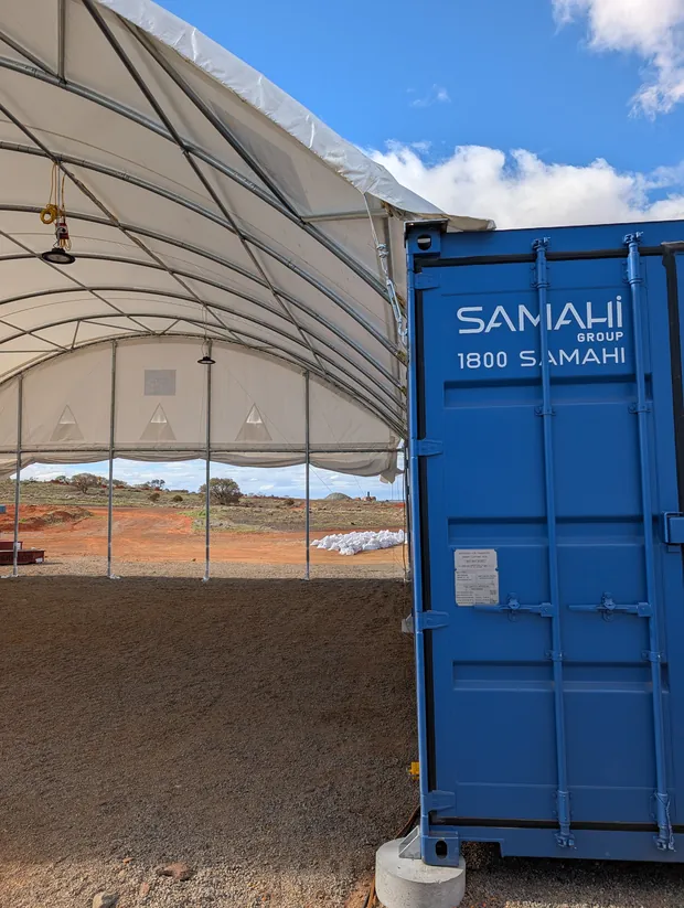 Interior of dome shelter showing the Samahi Group branded ablution block modified shipping container